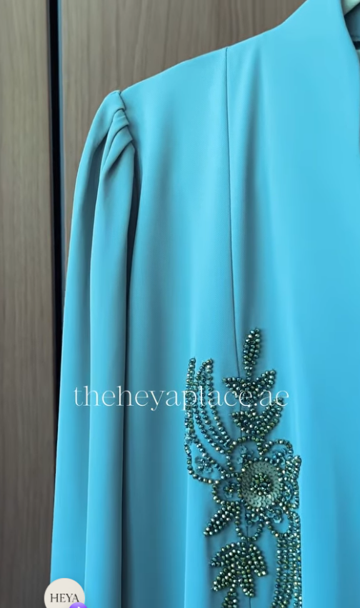 Aqua Grace Abaya in aqua blue with intricate botanical beadwork and an elegant flowing silhouette.