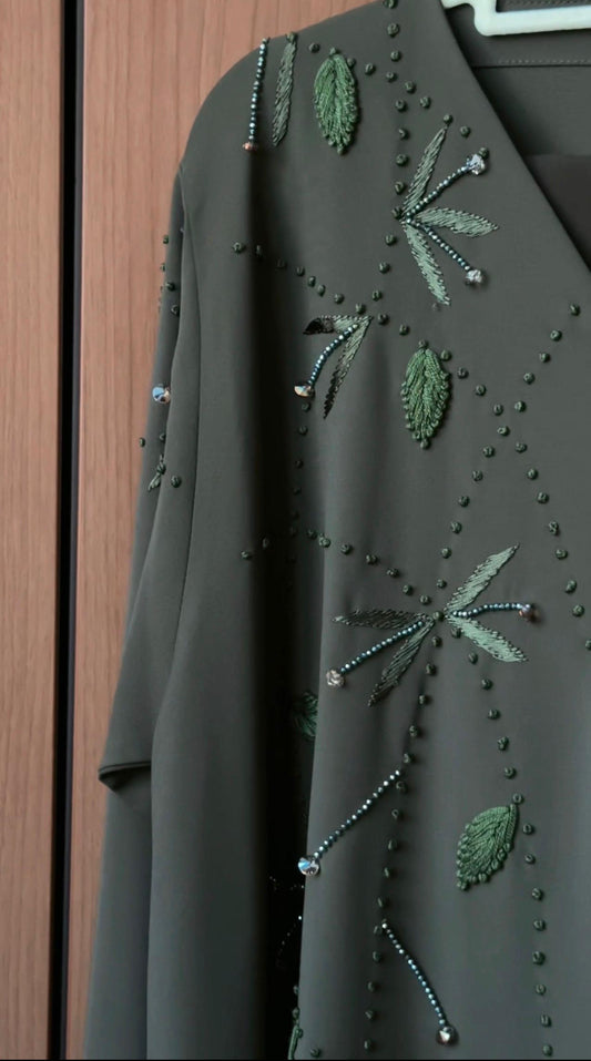 Front view of the Olive Briar Abaya with botanical embellishments