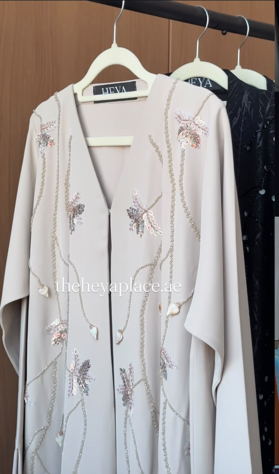 Luxury Pearl Meadow Abaya in ivory with handcrafted pearl vines, floral embellishments, and elegant modest design by HEYA.
