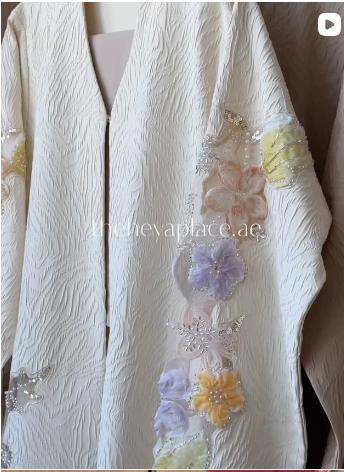 Blossom Veil Abaya in soft beige featuring 3D floral embroidery, pearl embellishments, and sheer embroidered sleeves