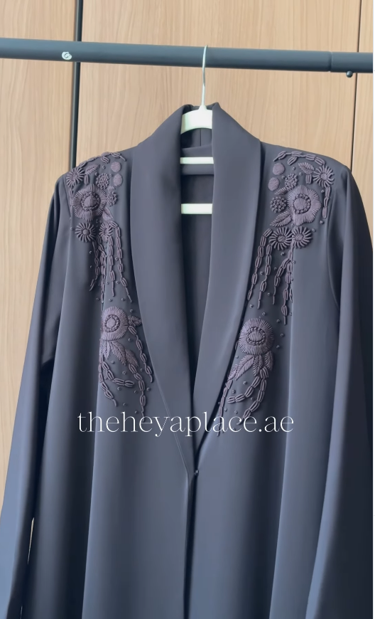 Dark Brown Blossom Abaya in charcoal black featuring handcrafted floral embroidery on the shawl collar with an elegant flowing silhouette.