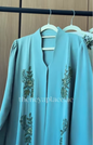 Aqua Grace Abaya in aqua blue with intricate botanical beadwork and an elegant flowing silhouette.