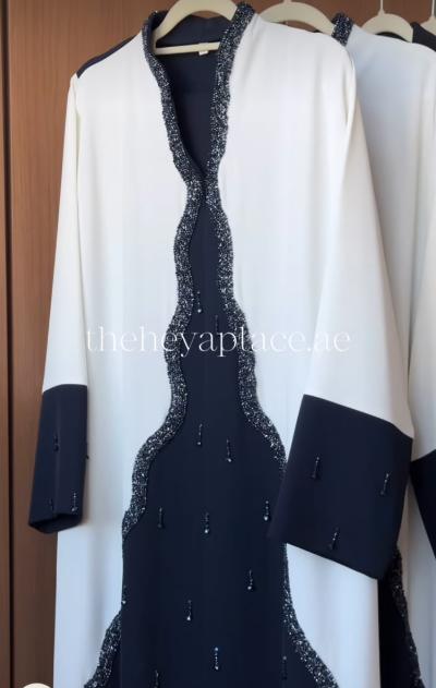 HEYA Black Swan Abaya in ivory and black with crystal-embellished detailing and contrasting black cuffs