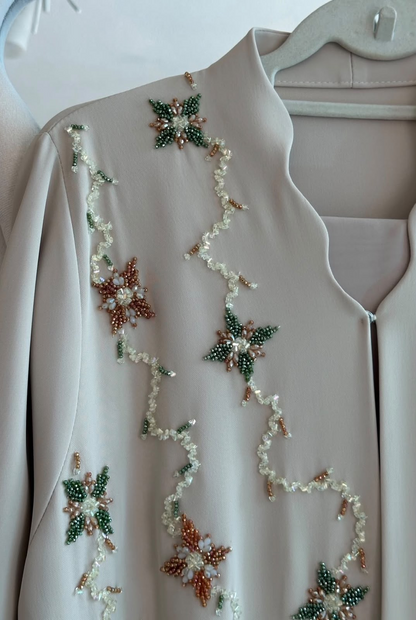 HEYA Champagne Garden Abaya with delicate botanical embellishments and an elegant flowing silhouette
