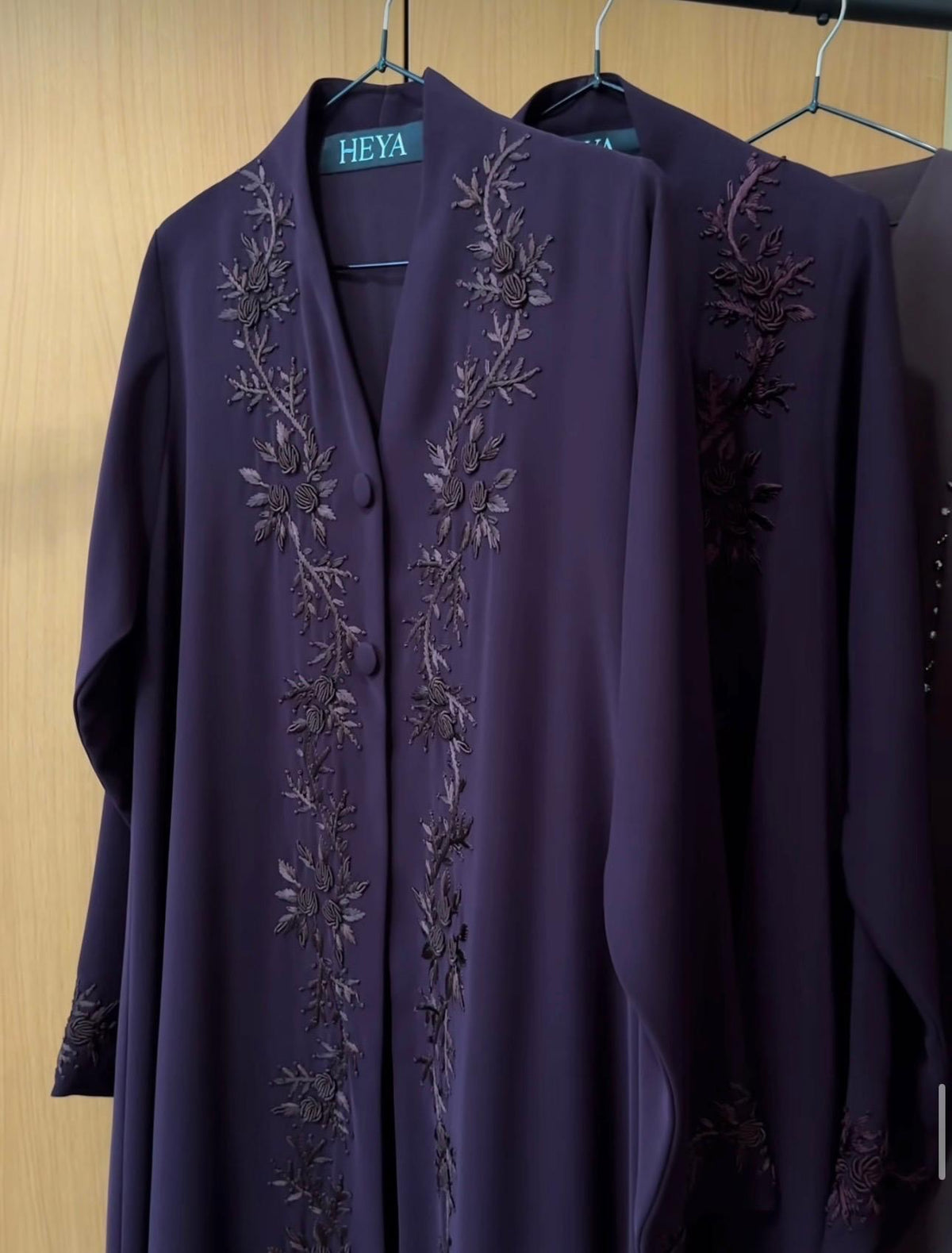 Deep Plum Abaya featuring elegant tonal floral embroidery on premium lightweight fabric with a graceful flowing silhouette.