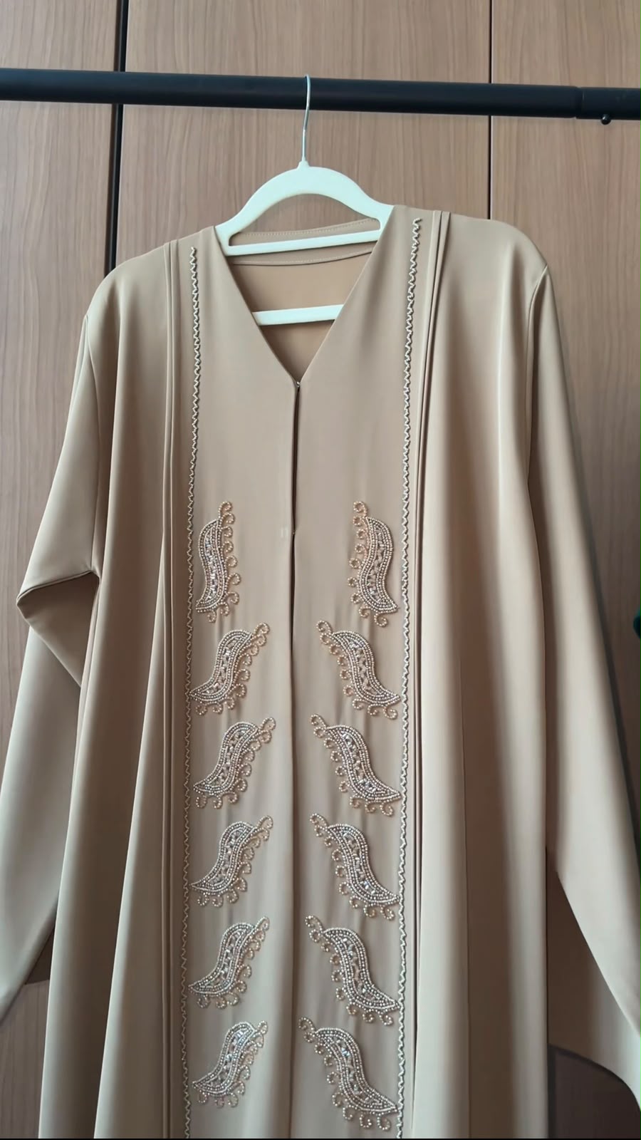 Desert Pearl Abaya in sand beige featuring handcrafted pearl paisley embellishments with a graceful flowing silhouette.