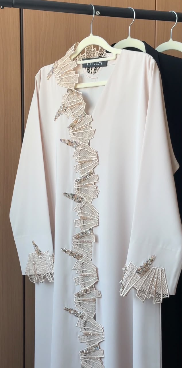 Durrah ivory abaya with intricate lace and shimmering crystal embellishments