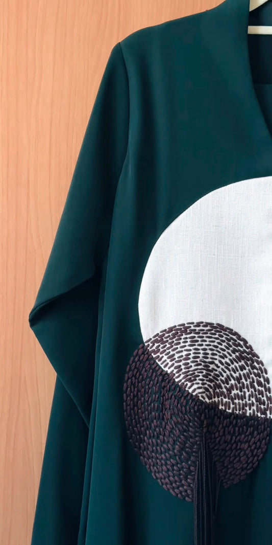 Front view of the emerald-green Elara Abaya with circular embroidered motifs