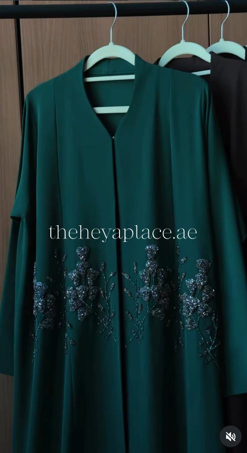 Emerald Noir Abaya in deep emerald green with shimmering floral beadwork and an elegant flowing silhouette.
