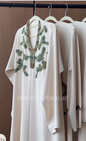 Emerald Vine Abaya in ivory with green and champagne beaded botanical embellishments and flowing sleeves.