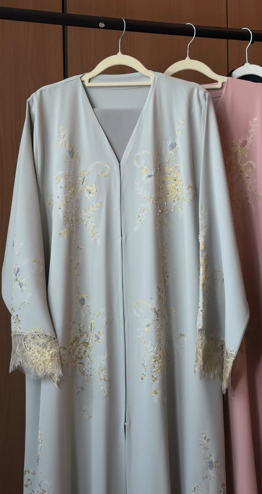 HEYA Noor Al Qamar light blue abaya with gold floral embroidery and lace cuffs