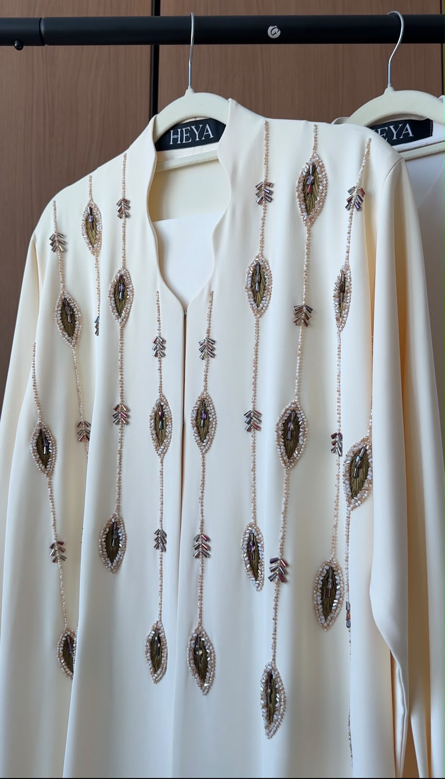 HEYA Ivory Cascade Abaya in ivory featuring cascading crystal embellishments, luxury modest fashion for women in the UAE.