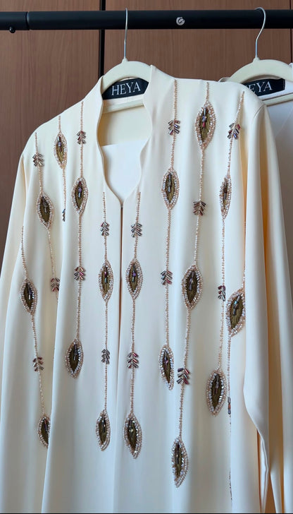 HEYA Ivory Cascade Abaya in ivory featuring cascading crystal embellishments, luxury modest fashion for women in the UAE.