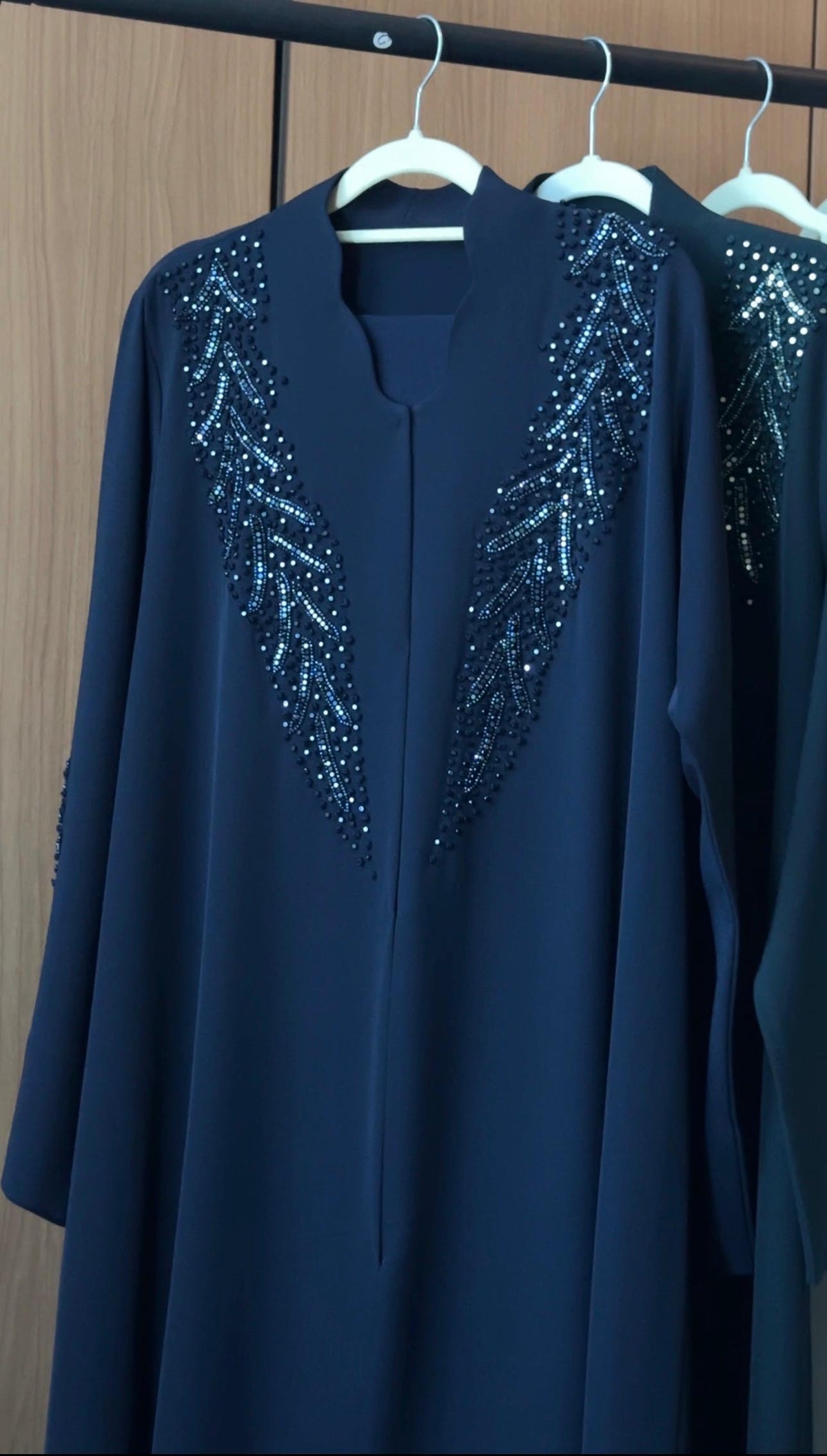 HEYA Ladybug navy blue abaya with shimmering leaf-inspired embellishments along the front and sleeves