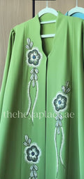 Lilly Green Abaya featuring a graceful flowing silhouette in premium lightweight fabric for women.
