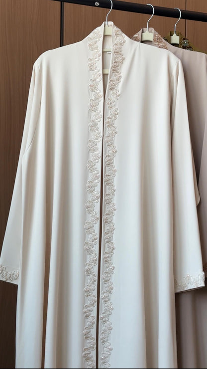 Lujain ivory abaya with delicate pearl-inspired embroidery along the front and cuffs