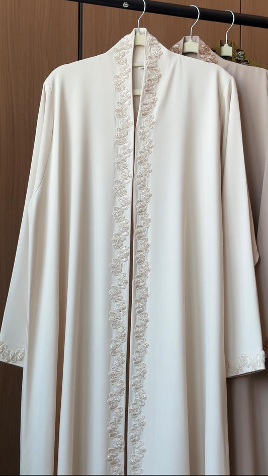 Lujain ivory abaya with delicate pearl-inspired embroidery along the front and cuffs