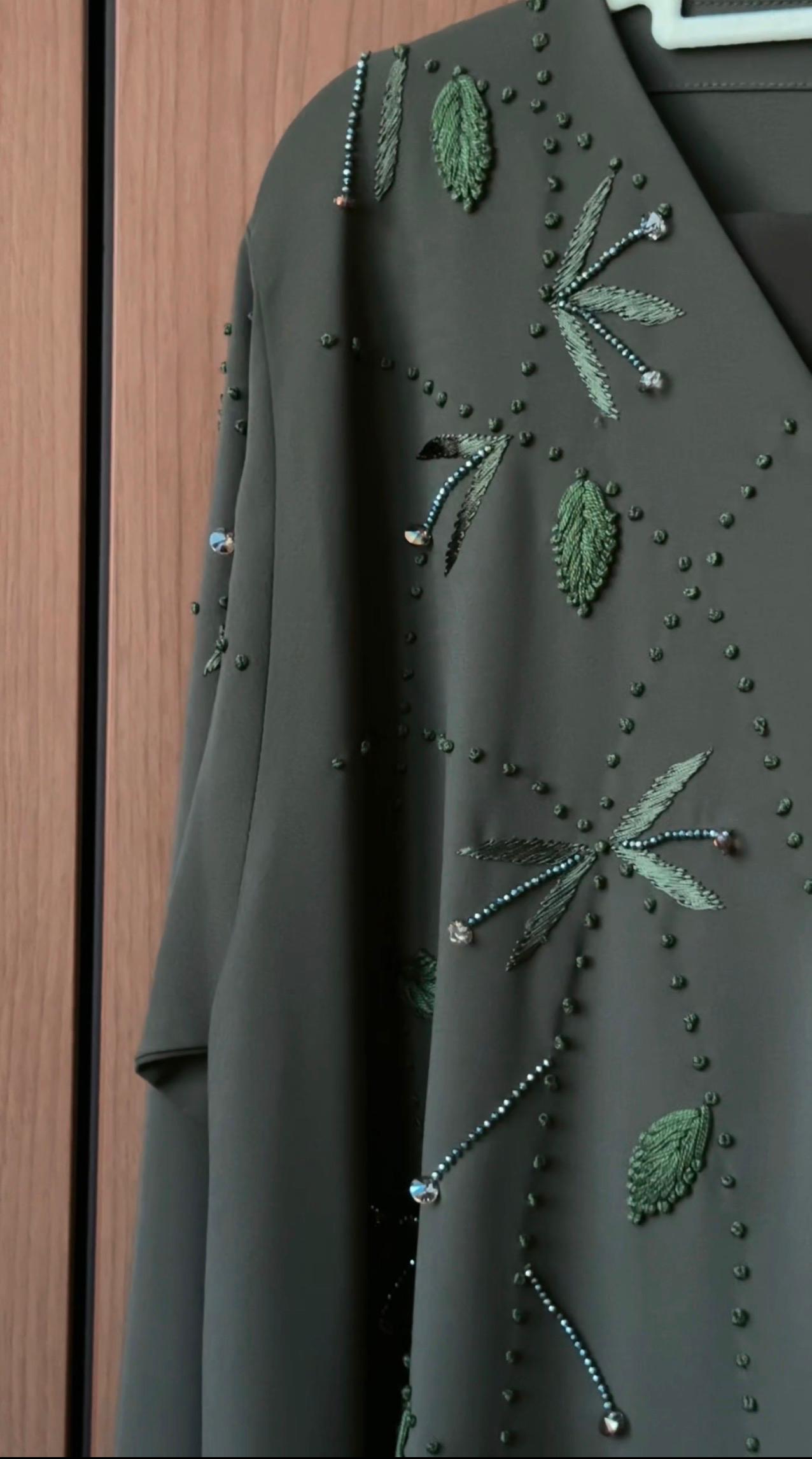 Front view of the Olive Briar Abaya with botanical embellishments