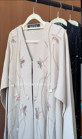 Luxury Pearl Meadow Abaya in ivory with handcrafted pearl vines, floral embellishments, and elegant modest design by HEYA.