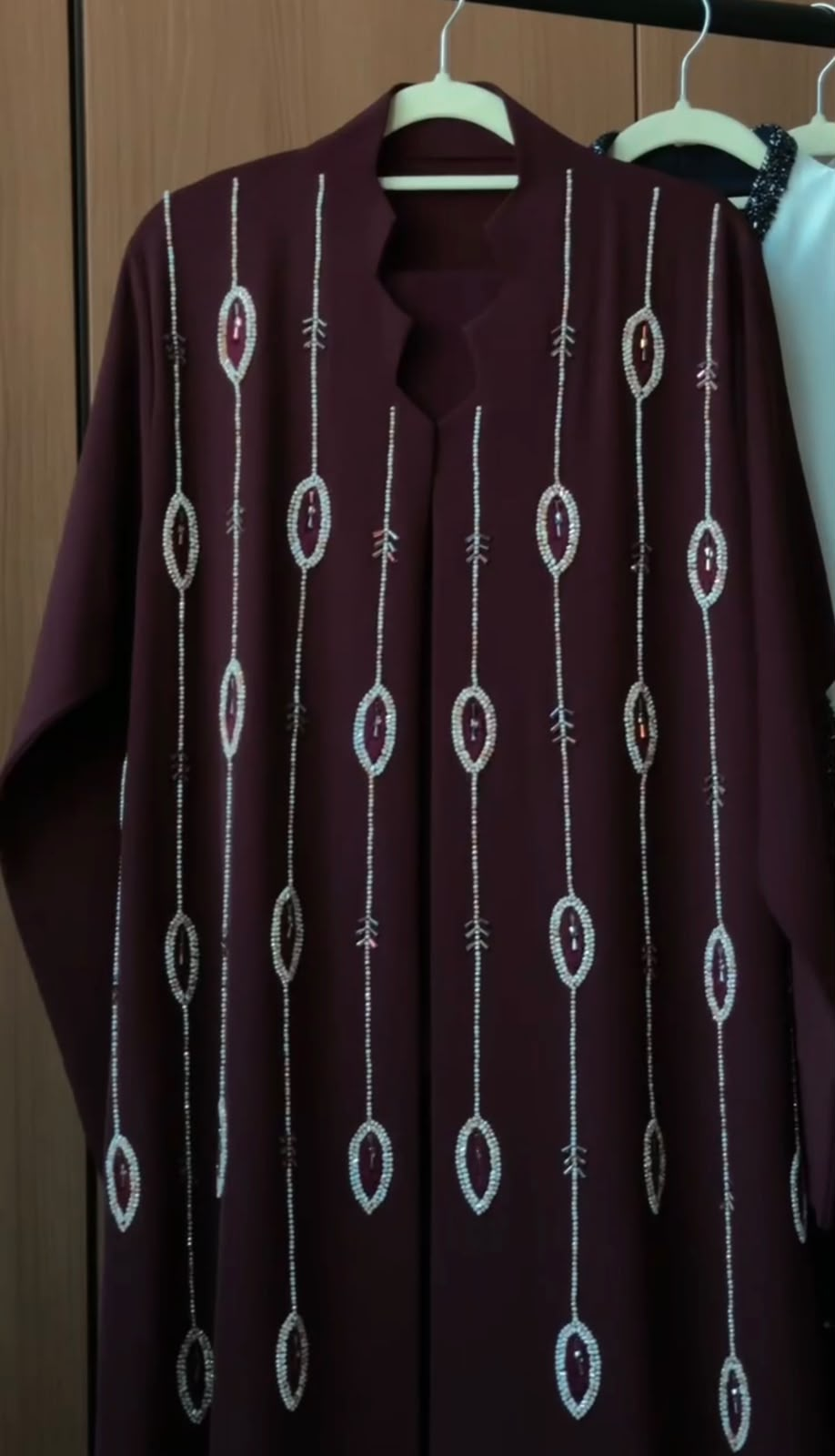 Royal Garnet Abaya in deep garnet burgundy featuring cascading vertical crystal beadwork and an elegant flowing silhouette.