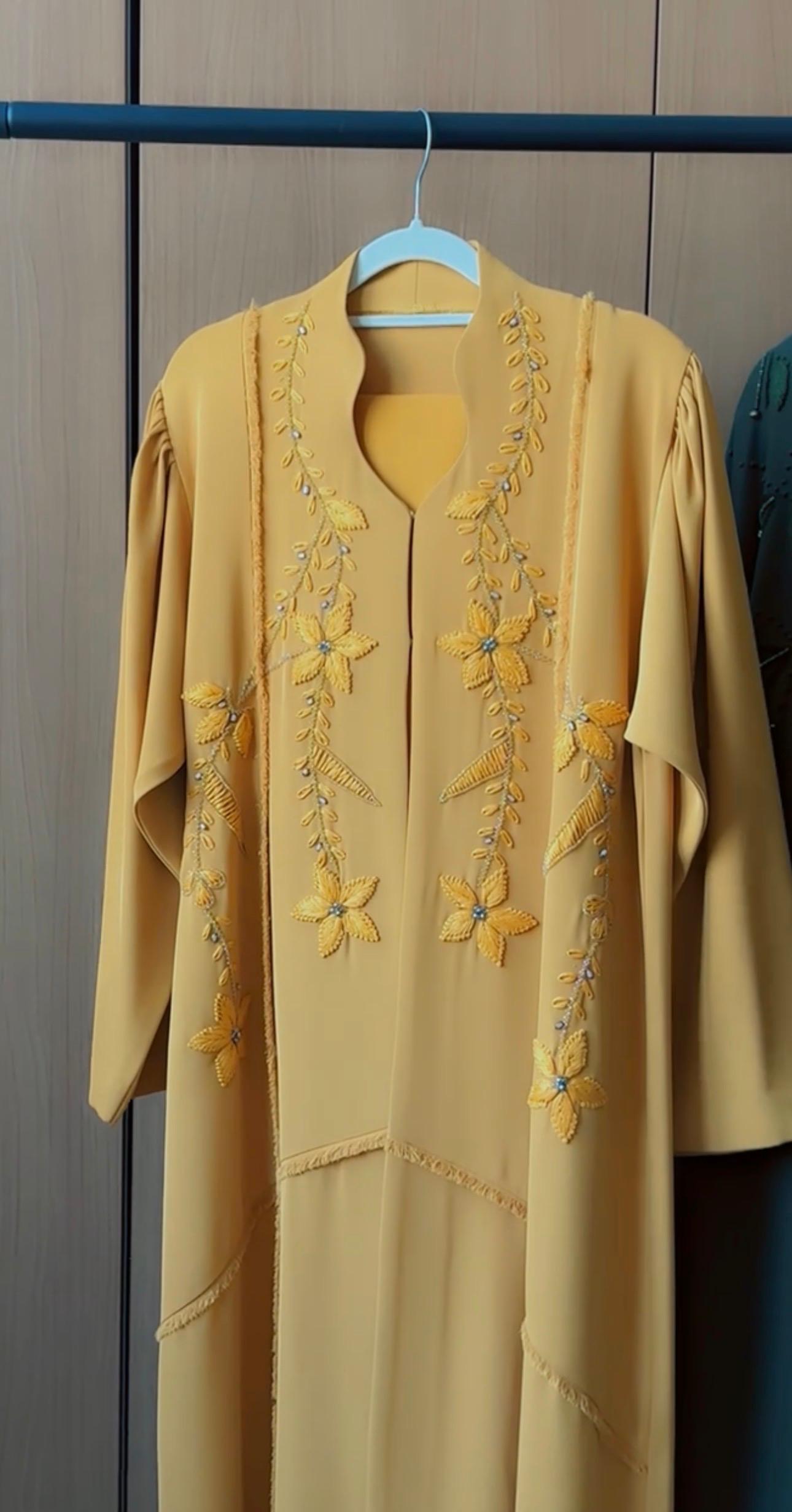 HEYA Saffron Blossom Abaya in golden yellow with floral vine embroidery and delicate crystal accents
