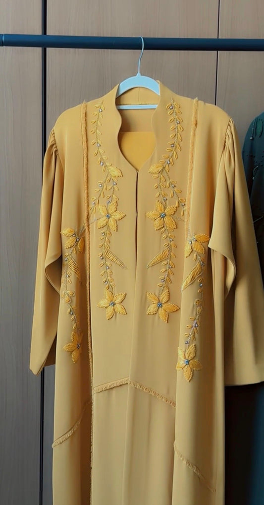 HEYA Saffron Blossom Abaya in golden yellow with floral vine embroidery and delicate crystal accents